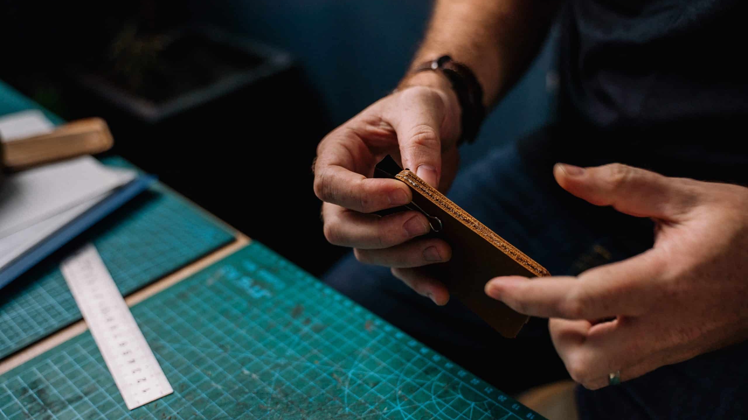 Craftsman who applies glue to leather